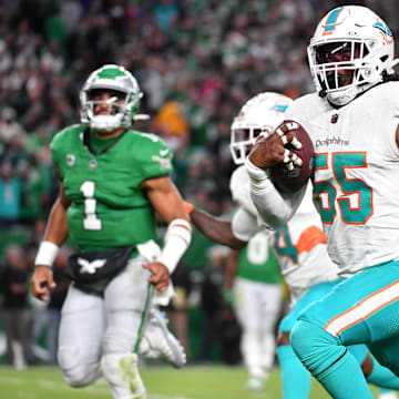 Miami Dolphins linebacker Jerome Baker (55) returns an interception for a touchdown  during the third quarter against the Philadelphia Eagles at Lincoln Financial Field in 2023.