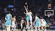 Oct 22, 2025; Charlotte, North Carolina, USA;  Charlotte Hornets center Ryan Kalkbrenner (11) and Brooklyn Nets center Nic Claxton (33) tip off the game at the Spectrum Center. Mandatory Credit: Sam Sharpe-Imagn Images