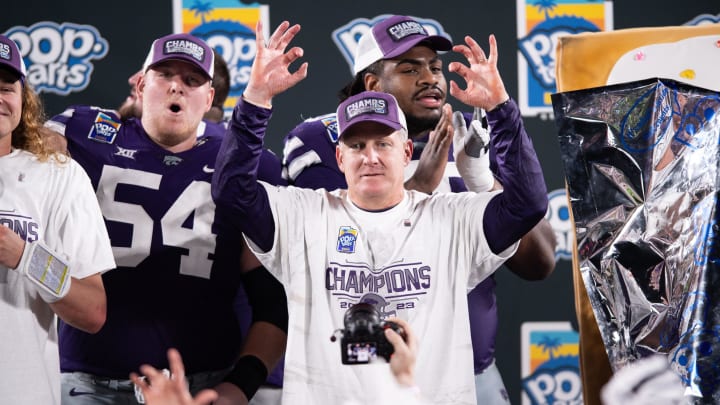 Dec 28, 2023; Orlando, FL, USA; Kansas State head coach Chris Klieman celebrates the victory over NC State after the game at Camping World Stadium. Mandatory Credit: Jeremy Reper-USA TODAY Sports