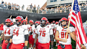 Sep 11, 2025; Winston-Salem, North Carolina, USA;  North Carolina State Wolfpack enter the field against for a game against the Wake Forest Demon Deacons at Allegacy Federal Credit Union Stadium. Mandatory Credit: Luke Jamroz-Imagn Images