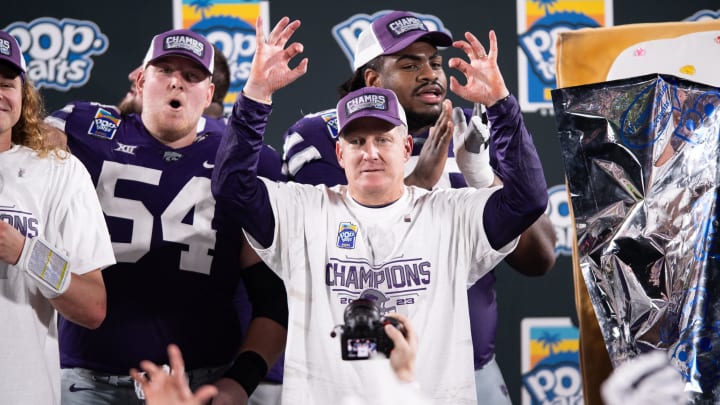 Dec 28, 2023; Orlando, FL, USA; Kansas State head coach Chris Klieman celebrates the victory over NC State after the game at Camping World Stadium. Mandatory Credit: Jeremy Reper-USA TODAY Sports