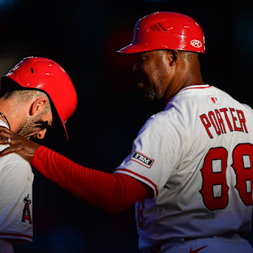 Angels third base coach Bo Porter (88) speaks with shortstop Zach Neto (9) during the first inning at Angel Stadium on Aug. 1.