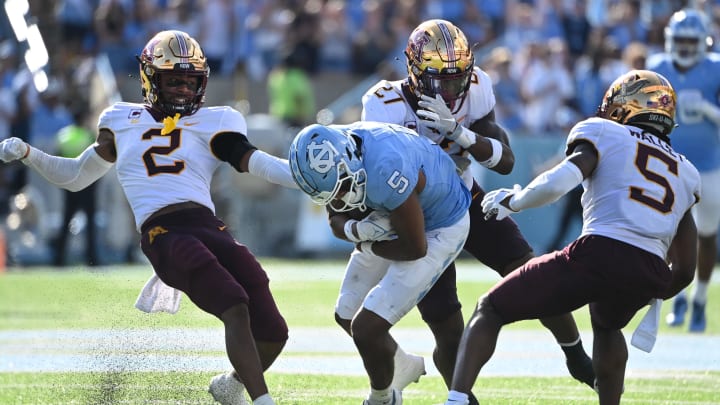 Sep 16, 2023; Chapel Hill, North Carolina, USA; North Carolina Tar Heels wide receiver J.J. Jones (5) catches the ball as Minnesota Golden Gophers defensive backs Tre'Von Jones (2) and Tyler Nubin (27) and Justin Walley (5) defend in the second quarter at Kenan Memorial Stadium.