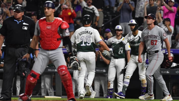 Jun 22, 2024; Denver, Colorado, USA; Colorado Rockies designated hitter Hunter Goodman (15) is greeted by shortstop Ezequiel Tovar (14) after scoring the tying run against the Washington Nationals in the ninth inning at Coors Field. 