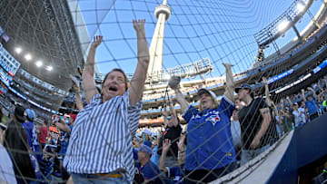 Sep 28, 2025; Toronto, Ontario, CAN;  Toronto Blue Jays fans celebrate after their team scored a run against the Tampa Bay Rays in the seventh inning at Rogers Centre. Mandatory Credit: Dan Hamilton-Imagn Images