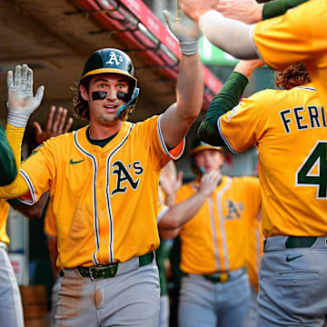Sep 6, 2025; Anaheim, California, USA; Athletics shortstop Jacob Wilson (5) is greeted after scoring a run against the Los Angeles Angels. during the first inning at Angel Stadium. Mandatory Credit: Gary A. Vasquez-Imagn Images