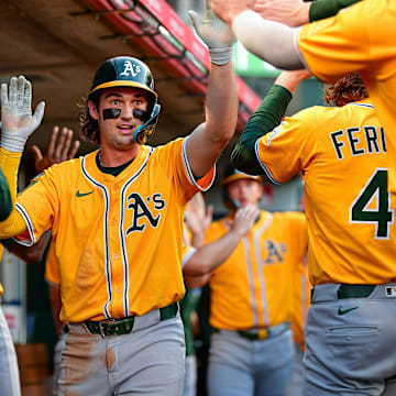Sep 6, 2025; Anaheim, California, USA; Athletics shortstop Jacob Wilson (5) is greeted after scoring a run against the Los Angeles Angels. during the first inning at Angel Stadium. Mandatory Credit: Gary A. Vasquez-Imagn Images