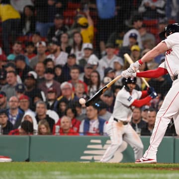 May 15, 2024; Boston, Massachusetts, USA; Boston Red Sox first baseman Garrett Cooper (28) hits a single against the Tampa Bay Rays during the sixth inning at Fenway Park. Mandatory Credit: Eric Canha-USA TODAY Sports