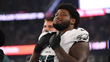 Aug 15, 2024; Foxborough, MA, USA; Philadelphia Eagles offensive tackle Fred Johnson (74) watches from the sideline during the second half against the New England Patriots at Gillette Stadium.