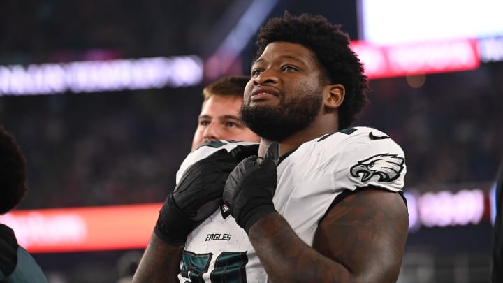 Aug 15, 2024; Foxborough, MA, USA; Philadelphia Eagles offensive tackle Fred Johnson (74) watches from the sideline during the second half against the New England Patriots at Gillette Stadium.