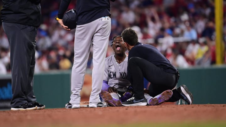 Jul 28, 2024; Boston, Massachusetts, USA;  New York Yankees  training staff check on center fielder Jazz Chisholm Jr (13) during the ninth inning against the Boston Red Sox at Fenway Park. Mandatory Credit: Eric Canha-USA TODAY Sports