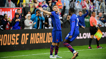 Christian Pulisic and Tim Weah celebrate a USMNT goal during a friendly match against Germany.