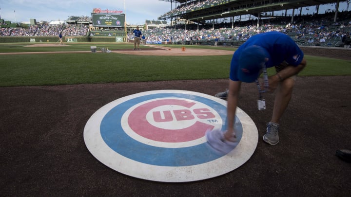 Jun 19, 2017; Chicago, IL, USA; A member of the grounds crew wipes off the Chicago Cubs' on deck logo prior to a game against the San Diego Padres at Wrigley Field. Mandatory Credit: Patrick Gorski-USA TODAY Sports