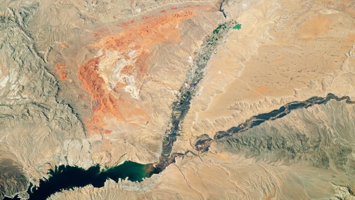 An astronaut onboard NASA's International Space Station took this photo of brightly colored rocks and deep canyons in the Mojave Desert on Feb. 25, 2020. The Muddy and Virgin Rivers cut through the desert to deliver water to Lake Mead reservoir. The red-orange rock exposures near the center of the photo mark the Valley of Fire State Park, about 40 miles to the northeast of Las Vegas. The image was taken by a member of the Expedition 62 crew.