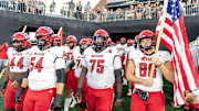 Sep 11, 2025; Winston-Salem, North Carolina, USA;  North Carolina State Wolfpack enter the field against for a game against the Wake Forest Demon Deacons at Allegacy Federal Credit Union Stadium. Mandatory Credit: Luke Jamroz-Imagn Images
