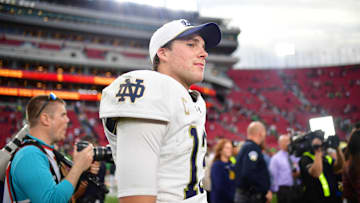 Nov 30, 2024; Los Angeles, California, USA; Notre Dame Fighting Irish quarterback Riley Leonard (13) reacts following the victory against the Southern California Trojans during the second half at the Los Angeles Memorial Coliseum. Mandatory Credit: Gary A. Vasquez-Imagn Images
