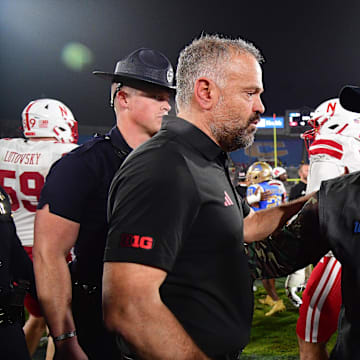 Nov 8, 2025; Pasadena, California, USA; Nebraska Cornhuskers head coach Matt Rhule meets with UCLA Bruins interim head coach Tim Skipper following the game at the Rose Bowl. Mandatory Credit: Gary A. Vasquez-Imagn Images