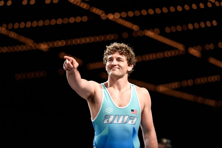 Olympian Ben Askren points to the crowd as he enters the mat to face fellow Olympian and New Jersey native Jordan Burroughs.