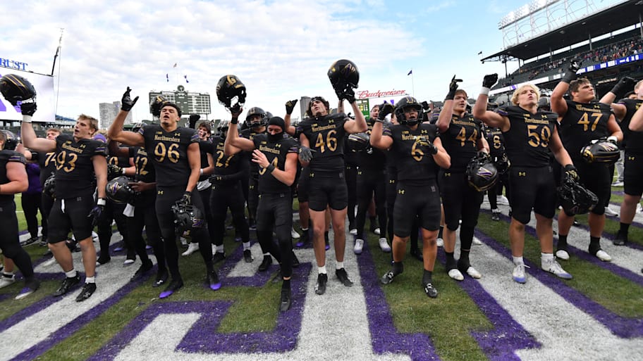 Northwestern football players celebrate after their victory against Minnesota.