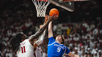 Feb 22, 2025; Tuscaloosa, Alabama, USA; Kentucky Wildcats forward Trent Noah (9) shoots against Alabama Crimson Tide forward Jarin Stevenson (15) and center Clifford Omoruyi (11) during the second half at Coleman Coliseum. Mandatory Credit: Will McLelland-Imagn Images