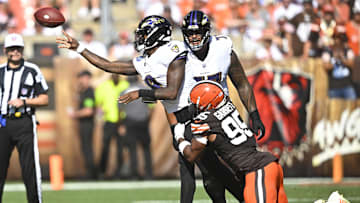 Oct 1, 2023; Cleveland, Ohio, USA; Baltimore Ravens quarterback Lamar Jackson (8) throws a pass as he is hit by Cleveland Browns defensive end Myles Garrett (95) in the third quarter at Cleveland Browns Stadium. Mandatory Credit: David Richard-Imagn Images
