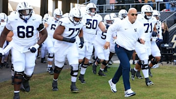 Penn State football head coach James Franklin running out with his team