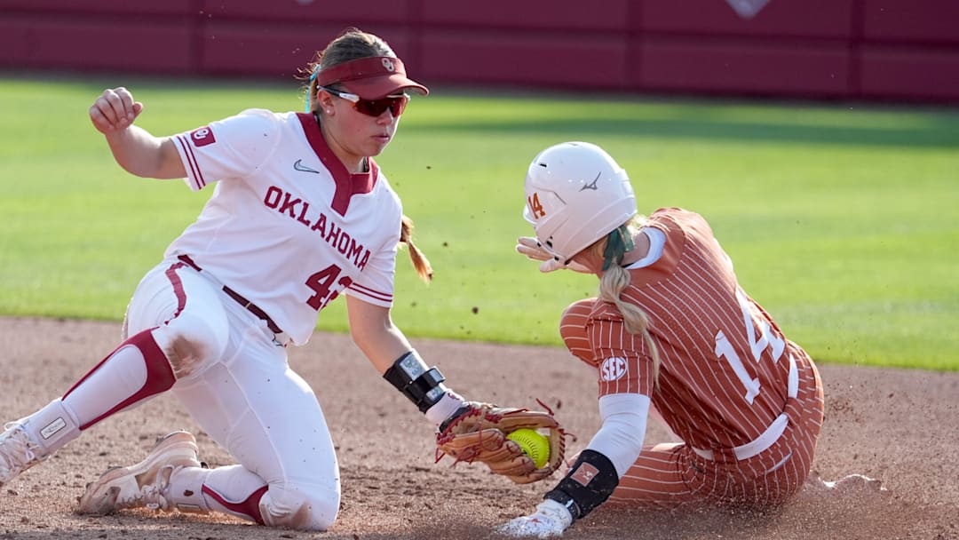 Texas's Reese Atwood (14) steals second as Oklahoma's Gabbie Garcia (42) tries to place the tag in the fourth inning during the college softball game between the University of Oklahoma Sooners and Texas Longhorns at Love's Field in Norman, Okla., Friday, April, 25, 2025.