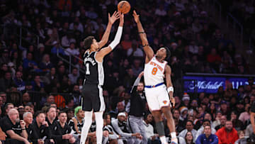 Dec 25, 2024; New York, New York, USA;  San Antonio Spurs center Victor Wembanyama (1) takes a three point shot past New York Knicks forward OG Anunoby (8) in the fourth quarter at Madison Square Garden. Mandatory Credit: Wendell Cruz-Imagn Images
