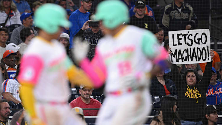 A fan holds a sign after San Diego Padres third baseman Manny Machado hits a home run