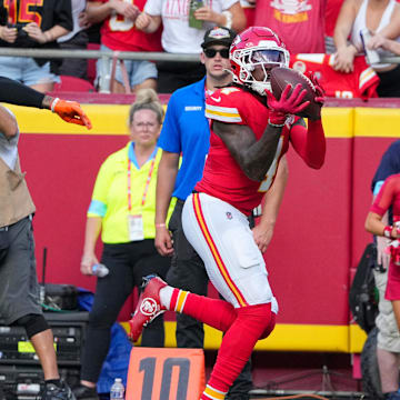 Sep 15, 2024; Kansas City, Missouri, USA; Kansas City Chiefs wide receiver Rashee Rice (4) catches a pass as Cincinnati Bengals cornerback Cam Taylor-Britt (29) misses the tackle during the first half at GEHA Field at Arrowhead Stadium. Mandatory Credit: Denny Medley-Imagn Images