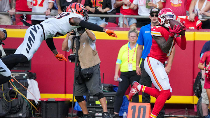 Sep 15, 2024; Kansas City, Missouri, USA; Kansas City Chiefs wide receiver Rashee Rice (4) catches a pass as Cincinnati Bengals cornerback Cam Taylor-Britt (29) misses the tackle during the first half at GEHA Field at Arrowhead Stadium. Mandatory Credit: Denny Medley-Imagn Images