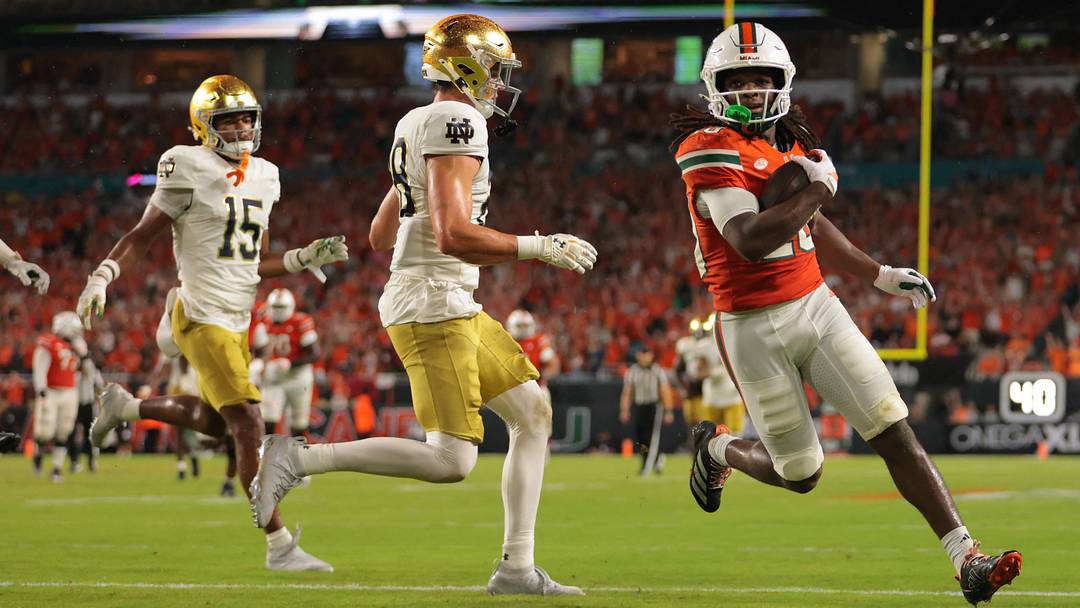 Aug 31, 2025; Miami Gardens, Florida, USA; Miami Hurricanes wide receiver Malachi Toney (10) scores a touchdown against the Notre Dame Fighting Irish during the first quarter at Hard Rock Stadium. Mandatory Credit: Sam Navarro-Imagn Images