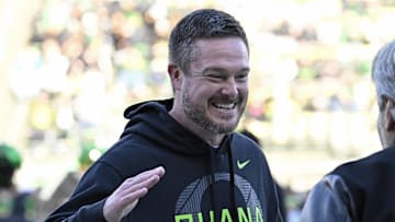 Nov 22, 2025; Eugene, Oregon, USA; Oregon Ducks head coach Dan Lanning smiles before the game against the Southern California Trojans at Autzen Stadium. Mandatory Credit: Troy Wayrynen-Imagn Images