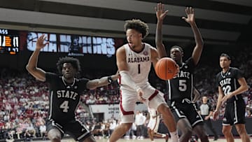 Feb 25, 2025; Tuscaloosa, AL, USA;  Alabama guard Mark Sears (1) drives into the lane and passes as he is defended by Mississippi State forward Cameron Matthews (4) and Mississippi State guard Shawn Jones Jr. (5) at Coleman Coliseum. Alabama defeated Mississippi State 111-73. 