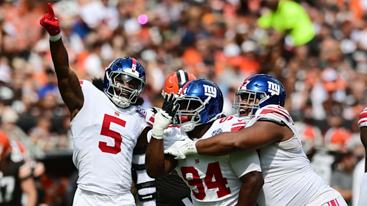 Sep 22, 2024; Cleveland, Ohio, USA; New York Giants linebacker Kayvon Thibodeaux (5) and defensive tackle Elijah Chatman (94) and defensive tackle Dexter Lawrence II (97) celebrate after sacking Cleveland Browns quarterback Deshaun Watson (not pictured) during the first quarter at Huntington Bank Field. Sep 22, 2024; Cleveland, Ohio, USA; New York Giants linebacker Kayvon Thibodeaux (5) and defensive tackle Elijah Chatman (94) and defensive tackle Dexter Lawrence II (97) celebrate after sacking Cleveland Browns quarterback Deshaun Watson (not pictured) during the first quarter at Huntington Bank Field.