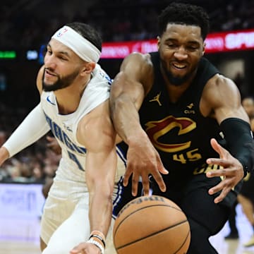 Cleveland Cavaliers guard Donovan Mitchell (45) goes for a loose ball against Orlando Magic guard Jalen Suggs (4) during the first half in game seven of the first round for the 2024 NBA playoffs at Rocket Mortgage FieldHouse.