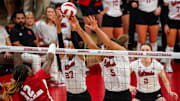 Nebraska Cornhuskers outside hitter Harper Murray (27) and middle blocker Bekka Allick (5) block Wisconsin Badgers outside hitter Temi Thomas-Ailara (12) in 2023.