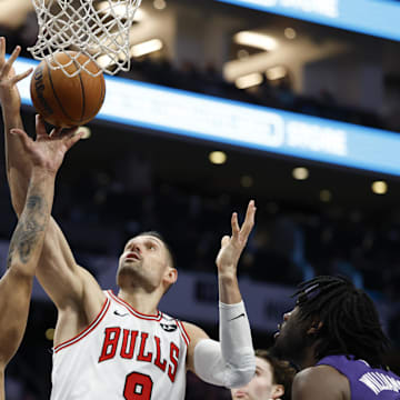 Apr 6, 2025; Charlotte, North Carolina, USA; Chicago Bulls center Nikola Vucevic (9) and Charlotte Hornets forward Miles Bridges (0) fight for a rebound during the second half at Spectrum Center. Mandatory Credit: Nell Redmond-Imagn Images