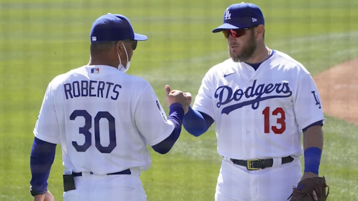 Mar 1, 2021; Glendale, Arizona, USA; Los Angeles Dodgers manager Dave Roberts (30) and first baseman Max Muncy (13) get ready for a spring training game against the Colorado Rockies at Camelback Ranch. Mandatory Credit: Rick Scuteri-Imagn Images