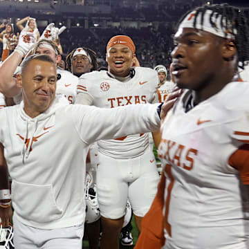 Texas Longhorns head coach Steve Sarkisian reacts with defensive linemen Colin Simmons after beating the Mississippi State Bulldogs in overtime at Davis Wade Stadium at Scott Field. 