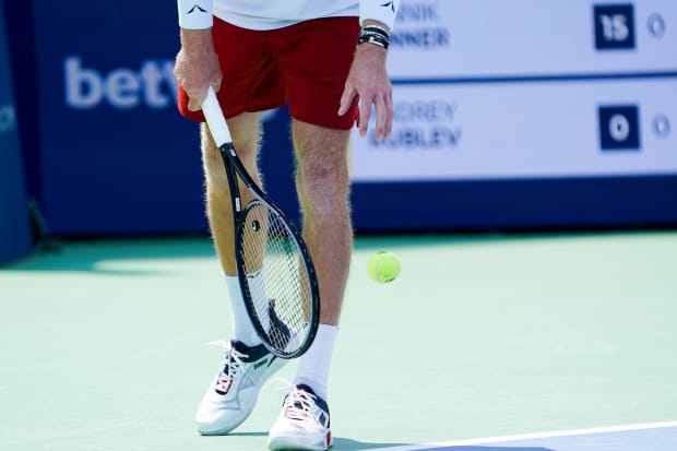 Andrey Rublev wears white and blue K-Swiss shoes.