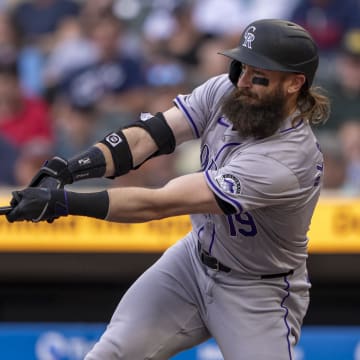 Jun 10, 2024; Minneapolis, Minnesota, USA; Colorado Rockies designated hitter Charlie Blackmon (19) hits a single against the Minnesota Twins in the first inning at Target Field.