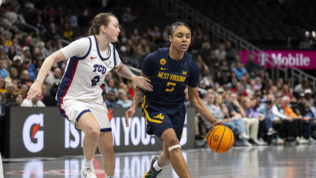 Mar 8, 2025; Kansas City, MO, USA; West Virginia Mountaineers guard Sydney Shaw (5) handles the ball while defended by TCU Horned Frogs guard Madison Conner (2) during the second half at T-Mobile Center. Mandatory Credit: Amy Kontras-Imagn Images Mar 8, 2025; Kansas City, MO, USA; West Virginia Mountaineers guard Sydney Shaw (5) handles the ball while defended by TCU Horned Frogs guard Madison Conner (2) during the second half at T-Mobile Center. Mandatory Credit: Amy Kontras-Imagn Images