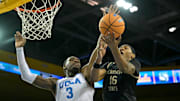 Nov 18, 2025; Los Angeles, California, USA;  UCLA Bruins forward Eric Dailey Jr. (3) stops a shot by Sacramento State Hornets guard Prophet Johnson (16) during the first half at Pauley Pavilion presented by Wescom Financial. Mandatory Credit: Jayne Kamin-Oncea-Imagn Images