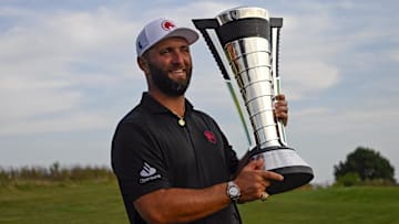 Jon Rahm holds the individual trophy after winning LIV Golf Chicago.