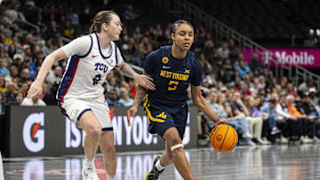 Mar 8, 2025; Kansas City, MO, USA; West Virginia Mountaineers guard Sydney Shaw (5) handles the ball while defended by TCU Horned Frogs guard Madison Conner (2) during the second half at T-Mobile Center. Mandatory Credit: Amy Kontras-Imagn Images
