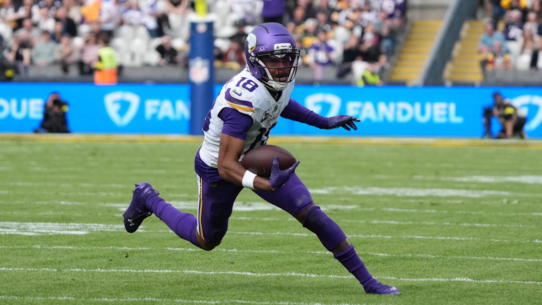 Sep 28, 2025; Dublin, Ireland; Minnesota Vikings wide receiver Justin Jefferson (18) runs for a gain during the second quarter against the Pittsburgh Steelers during an NFL International Series game at Croke Park. Mandatory Credit: Kirby Lee-Imagn Images
