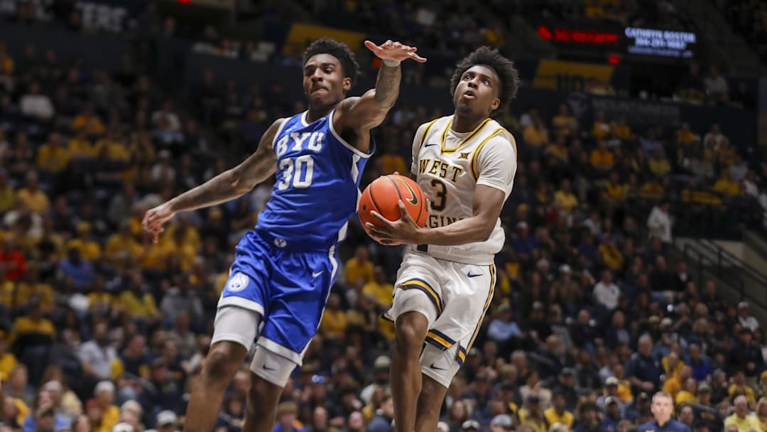 Feb 28, 2026; Morgantown, West Virginia, USA; West Virginia Mountaineers guard Honor Huff (3) shoots in the lane against BYU Cougars guard Kennard Davis Jr. (30) during the second half at Hope Coliseum. Mandatory Credit: Ben Queen-Imagn Images
