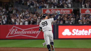 Sep 13, 2024; Bronx, New York, USA; New York Yankees center fielder Aaron Judge (99) celebrates while running the bases after hitting a grand slam home run during the seventh inning against the Boston Red Sox at Yankee Stadium. Mandatory Credit: Vincent Carchietta-Imagn Images