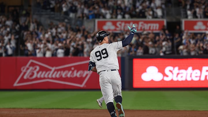 Sep 13, 2024; Bronx, New York, USA; New York Yankees center fielder Aaron Judge (99) celebrates while running the bases after hitting a grand slam home run during the seventh inning against the Boston Red Sox at Yankee Stadium. Mandatory Credit: Vincent Carchietta-Imagn Images